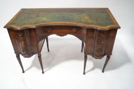 An Edwardian mahogany lady's writing desk with green leather inset top over an arrangement of seven