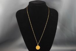 A French gold St Christopher pendant, on an Italian fancy fetter link chain, stamped '9k',
