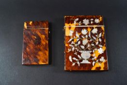A Victorian tortoiseshell card case with mother of pearl inlay in the form of an urn of flowers to