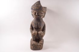 An ethnographic carved wooden figure, possibly from the South Seas,