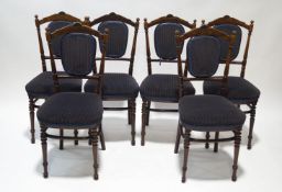 A set of six Edwardian beech dining chairs with turned uprights, padded slats,