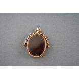 A late Victorian 9ct rose gold, bloodstone and cornelian spinning fob with a curb link surmount,