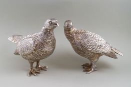 A pair of silver partridges, the cock and hen each modelled standing in a naturalistic pose,
