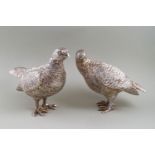 A pair of silver partridges, the cock and hen each modelled standing in a naturalistic pose,