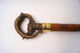 A Japanese walking stick, the shaft carved with a snake chasing a frog,