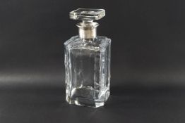A silver collared cut glass decanter with triple faceted edges and square stopper,
