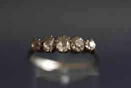 An early 20th century platinum and diamond five stone ring, the graduated old-cut stones approx. 1.