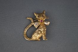 A 9 carat gold 'pussy cat' brooch with small sapphire eyes and wearing a ruby and diamond bow tie,