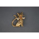 A 9 carat gold 'pussy cat' brooch with small sapphire eyes and wearing a ruby and diamond bow tie,