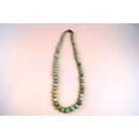 A pale green and mottled jadeite bead necklace, the 65 round beads graduated approx. 10.00mm to 4.