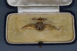 An early 20th century gold and enamel RAF 'Wings' brooch, stamped '9ct', later steel pin, 40mm wide,