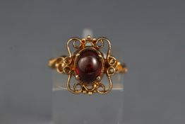 A 9ct gold and garnet single stone ring,