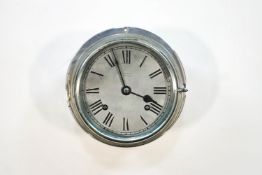 A chromed bulkhead clock by R Barrett of Ipswich, 20cm diameter at widest point,