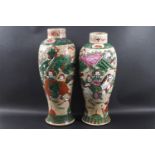 A near pair of Chinese crackle glaze vases, each decorated with scenes of fighting warriors, 27.