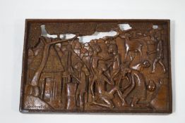 An African carved hardwood wall plaque depicting villagers, signed C B Nooneta,
