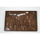 An African carved hardwood wall plaque depicting villagers, signed C B Nooneta,