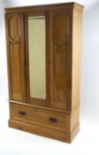 A Victorian pine hallrobe with mirrored central door above a base drawer,