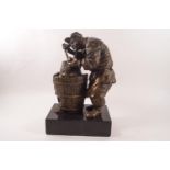 A 20th century bronze patinated figure of a Japanese peasant cooking vegetables,