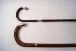 A slim walking stick with silver collar and tip, hallmarked Birmingham 1913,
