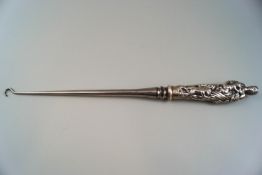 An unusually large late Victorian silver mounted steel button hook,