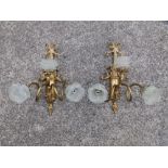 A pair of gilt metal reproduction style wall lights.