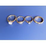 Two small diamond rings and two others. (4)