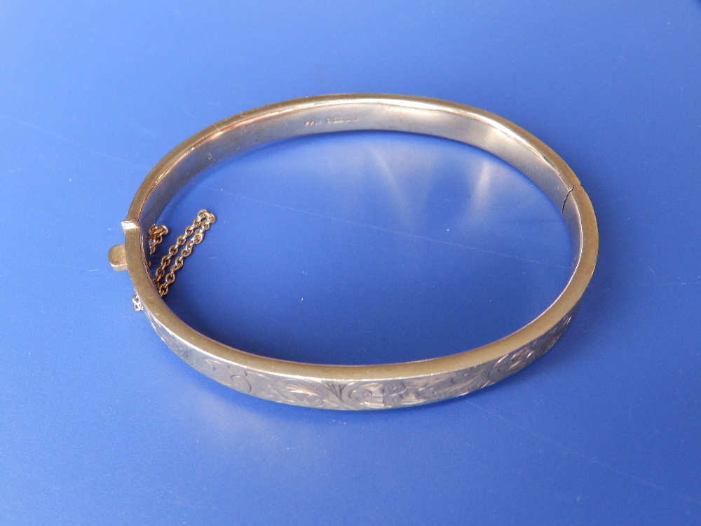 A 9ct gold bangle.