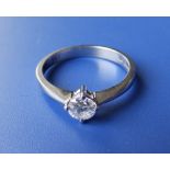 A modern diamond solitaire set platinum ring, the four-claw set brilliant cut stone weighing 0.33