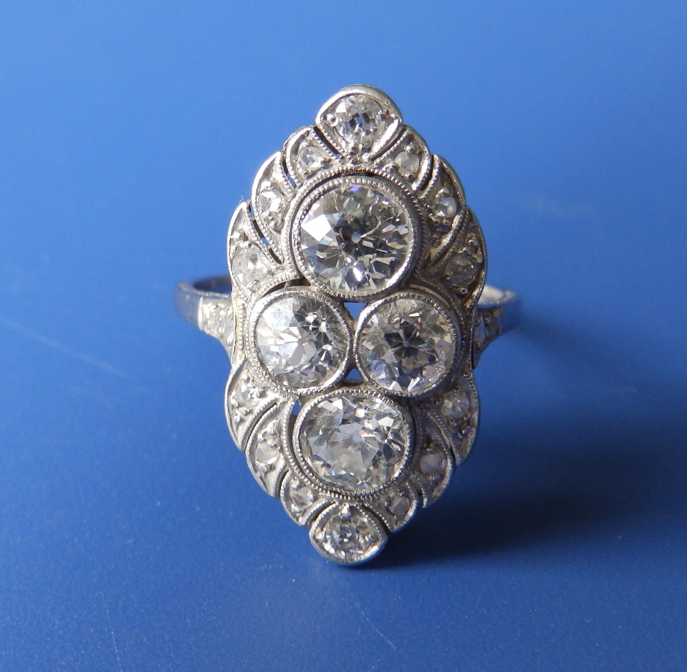 A diamond set white metal cocktail ring, having four millegrain set old cut stones to centre,