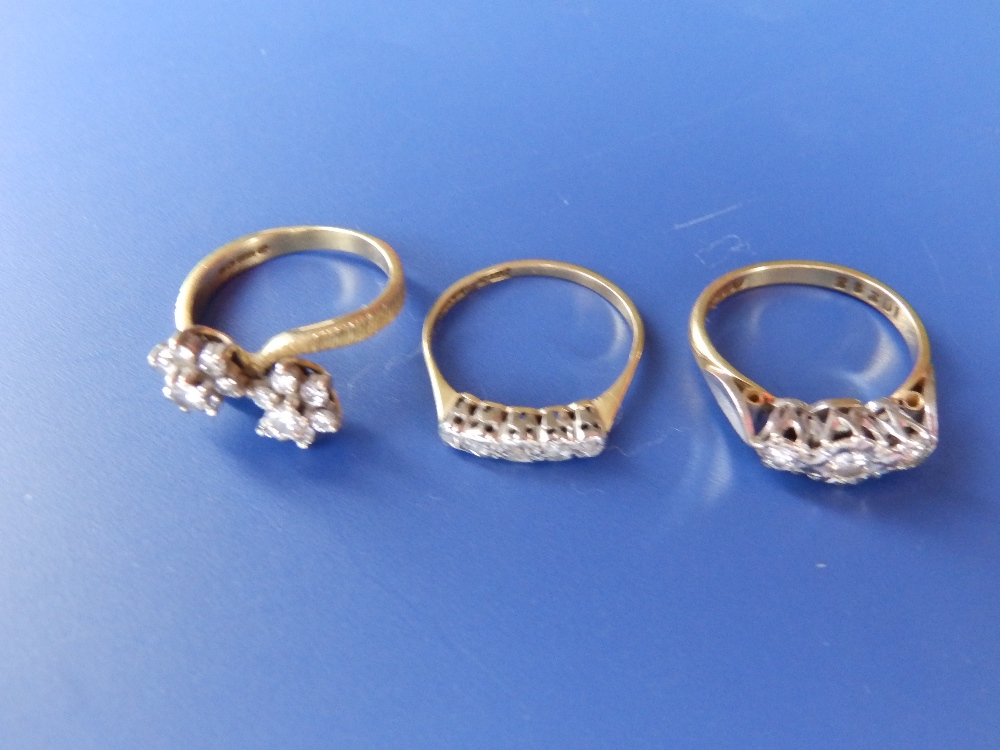 A diamond illusion set ring and two others. (3)