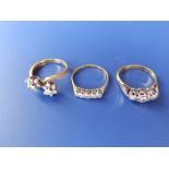 A diamond illusion set ring and two others. (3)