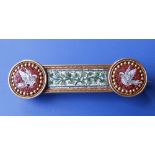 A 19thC Italian micro-mosaic brooch, of slender panel form, inlaid with a vine and two doves.
