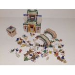 A collection of miniature Chinese ceramic figures, including two buildings and two bridges.