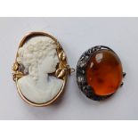 A cameo brooch and an art nouveau amber brooch. (2)
