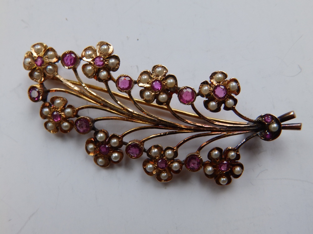 A French yellow metal leaf brooch set with pearls & ruby coloured stones.