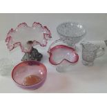 A Victorian centrepiece with cranberry glass frilled rim, a cranberry glass basket and bowl and