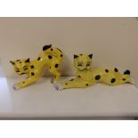 A pair of Lorna Bailey yellow glazed reclining cats.