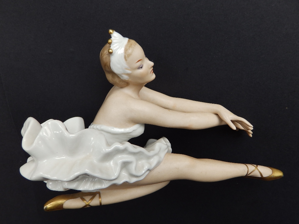 A 20thC German porcelain seated ballerina.