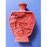 A Chinese cinnabar lacquer snuff bottle of flattened shouldered form depicting figures, a house,