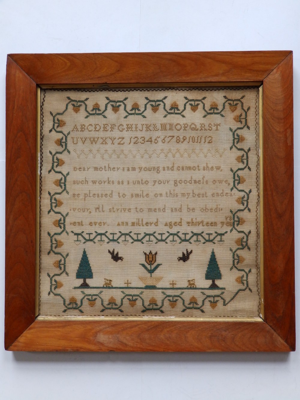 A Victorian silkwork sampler – Ann Millard, Aged 13, 15.5” x 15” - stained.