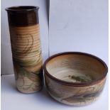 A mid-20thC studio pottery cylinder vase, 13.5” high and matching bowl with slip decoration. (2)