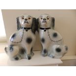 A pair of early 20thC Sadler pottery spaniels with glass eyes.