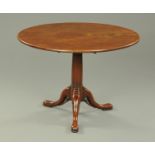A George III mahogany tripod table, with snap action and gun barrel column. Diameter 98 cm.