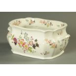 A Victorian earthenware foot bath, decorated with floral sprays. Length 47 cm.