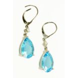 A pair of 18 ct white gold pear shaped blue topaz and diamond drop earrings, topaz weight +/- 10.