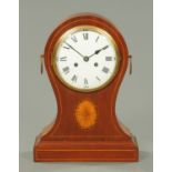 A large Edwardian mahogany balloon clock, with two-train movement. Height 43 cm, width 31 cm.