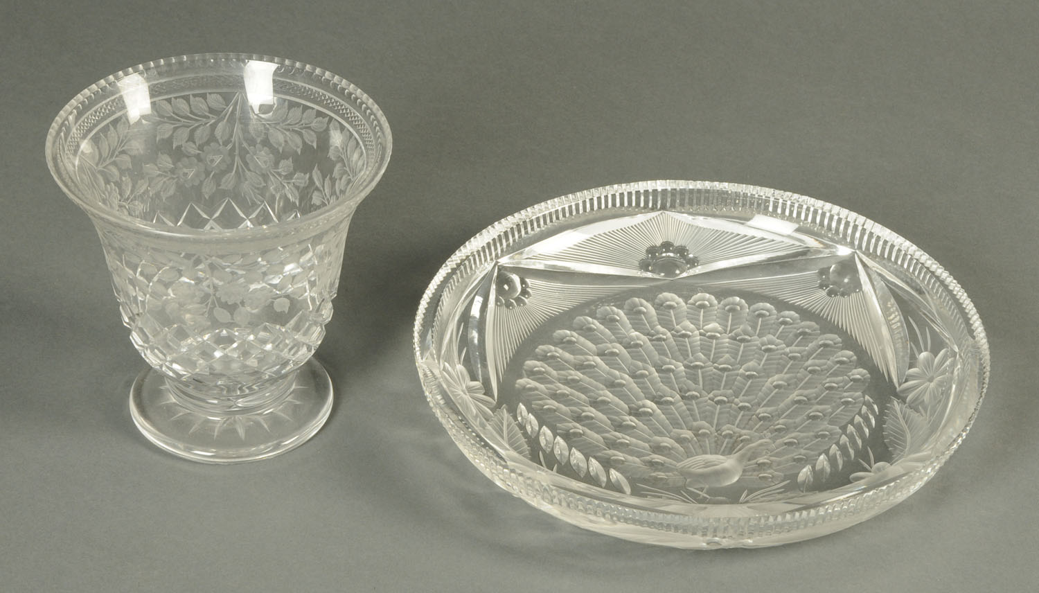 A cut glass dish, decorated with a peacock, and a cut glass vase. Dish diameter 29.5 cm.