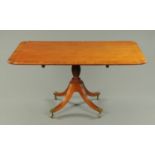 A George III mahogany breakfast table, with crossbanded top,