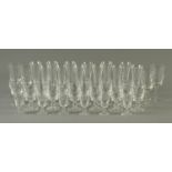 A part suite of drinking glasses, including 12 champagne flutes, 4 large wine glasses,