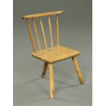 An antique primitive ash stool, with five spindled back,